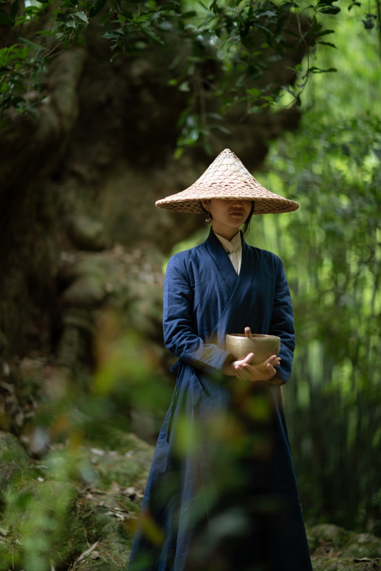 Meditative practitioner holding a singing bowl in a serene forest sanctuary